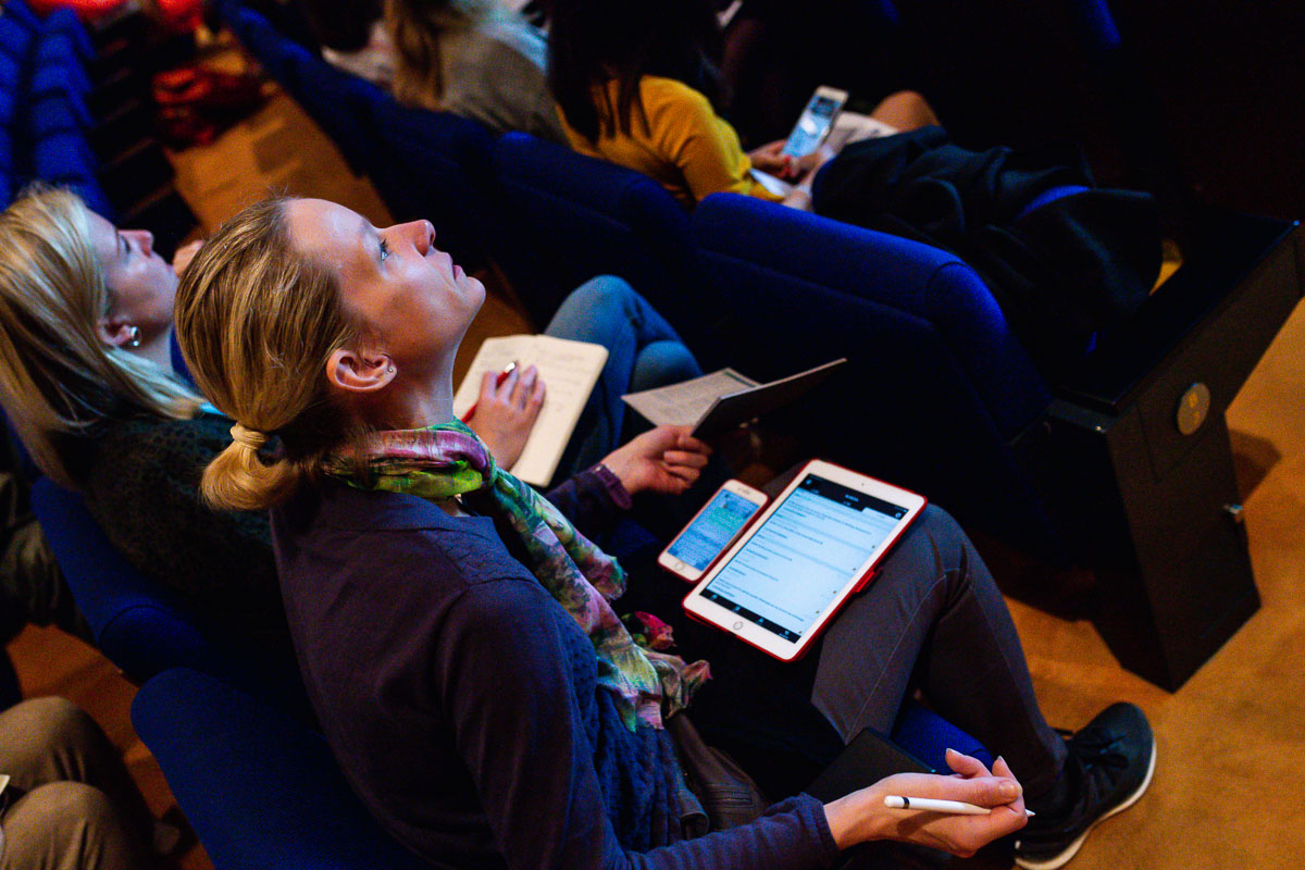 Detail of participants taking notes during the EWPN Conference, with event photographer Sandra Stokmans